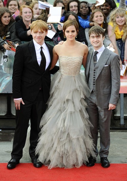 Actress Emma Watson poses with fellow cast members Daniel Radcliffe and Rupert Grint as they arrive for the world premiere of "Harry Potter and the Deathly Hallows: Part 2" at Trafalgar Square in London